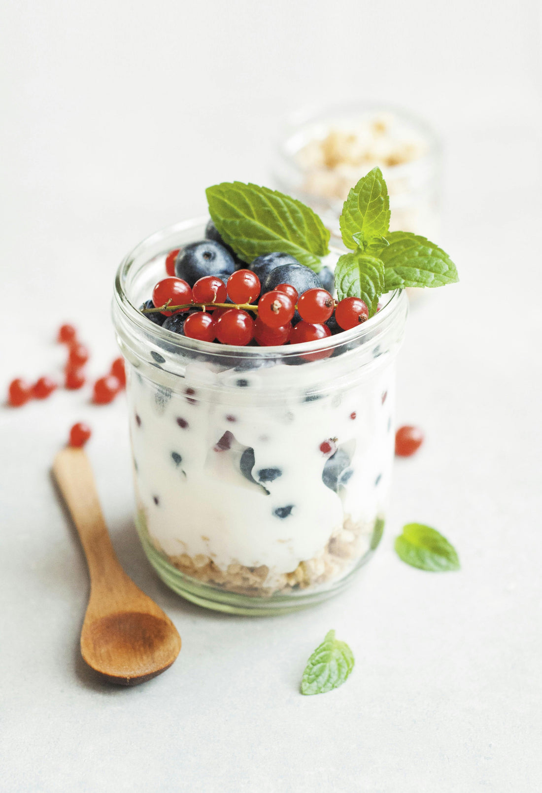 minimal yogurt bowl on a white table with spoon